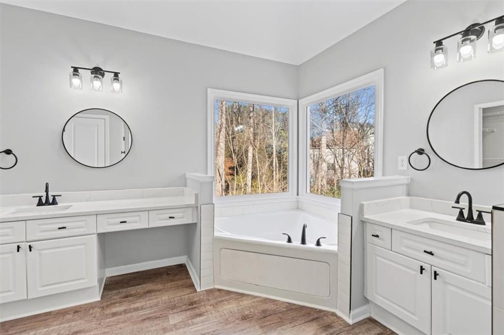 1038 Middlebrooke Drive Canton, GA 30115 - Photo 34 of 76 a bathroom with a double vanity sink mirror and a bathtub