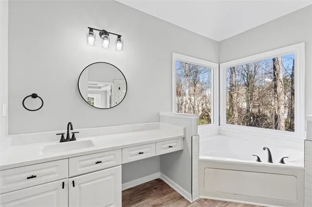 an empty room with a window and a ceiling fan