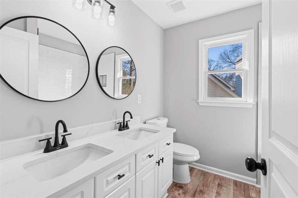 1038 Middlebrooke Drive Canton, GA 30115 - Photo 42 of 76 a bathroom with a toilet a sink and a mirror