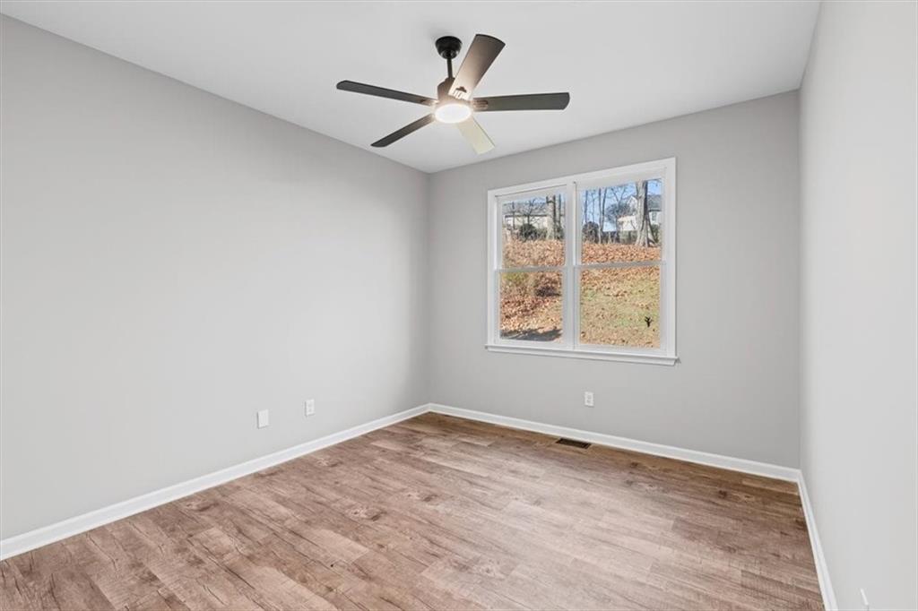 1038 Middlebrooke Drive Canton, GA 30115 - Photo 43 of 76 an empty room with a window and a fan