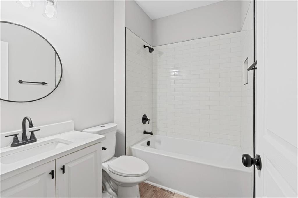 1038 Middlebrooke Drive Canton, GA 30115 - Photo 44 of 76 a bathroom with a sink a toilet and a mirror