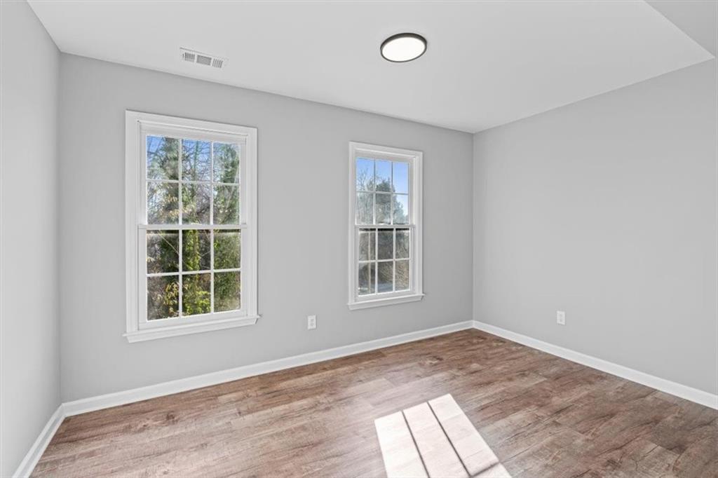 1038 Middlebrooke Drive Canton, GA 30115 - Photo 45 of 76 an empty room with wooden floor and windows