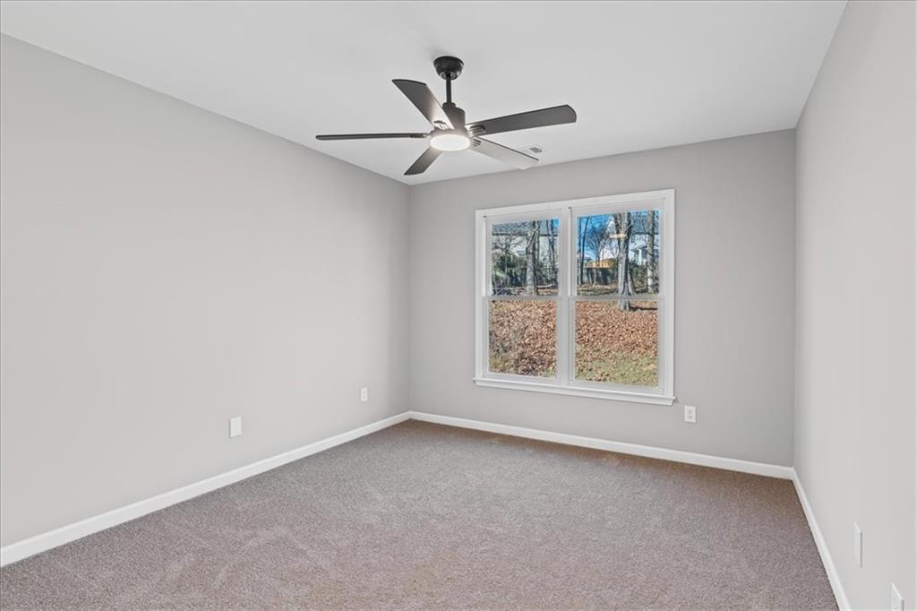 1038 Middlebrooke Drive Canton, GA 30115 - Photo 49 of 76 an empty room with a window and a ceiling fan