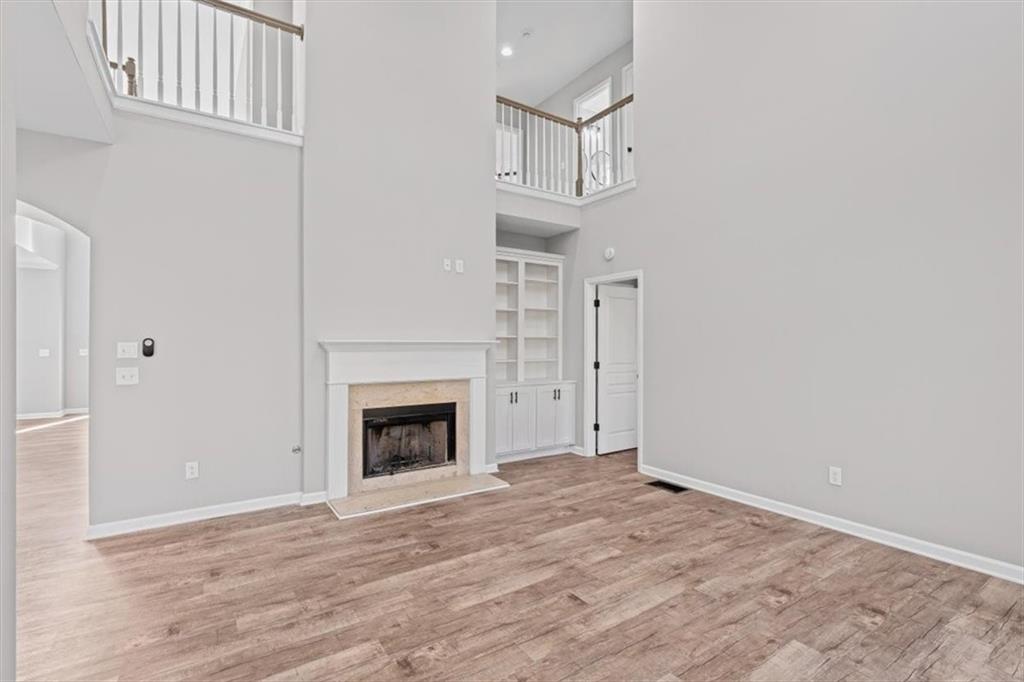 1038 Middlebrooke Drive Canton, GA 30115 - Photo 10 of 76 a view of an empty room with wooden floor fireplace and a window