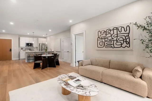 a living room with furniture kitchen area and kitchen view