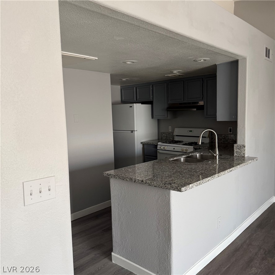 1830 North Pecos Road, Unit 258 Las Vegas, NV 89115 - Photo 11 of 14 A well-appointed kitchen showcases sleek granite countertops and modern appliances.
