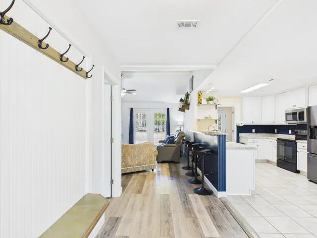 a view of livingroom with furniture and large windows