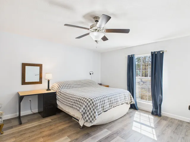 a bedroom with a large bed and a chandelier