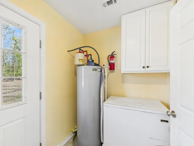 a view of a house with a yard covered in snow