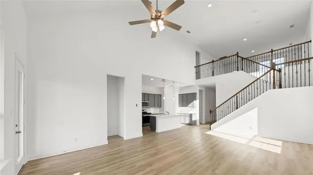 a view of entryway and kitchen with wooden floor