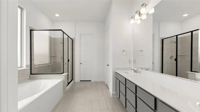 a bathroom with a tub a sink and mirrors