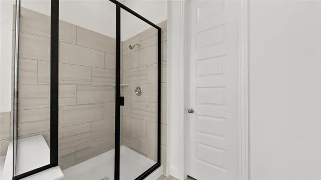a bathroom with a glass shower door