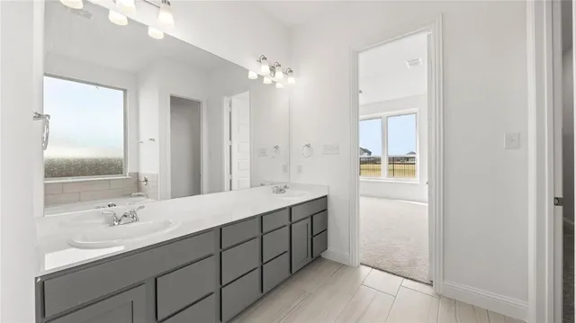 a bathroom with a double vanity sink mirror and