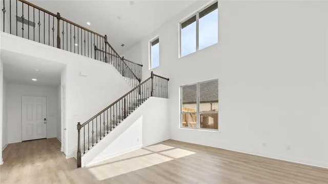 a view of staircase with white walls and a window
