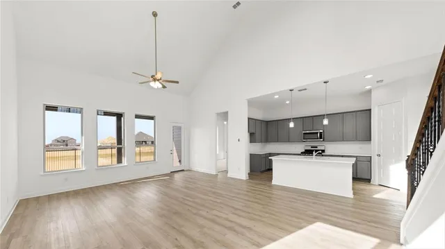 a view of kitchen with sink microwave refrigerator and stove