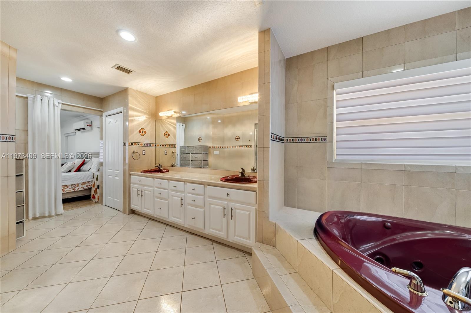 13050 Southwest 26th Street Miami, FL 33175 - Photo 21 of 43 a bathroom with a granite countertop sink mirror and bathtub