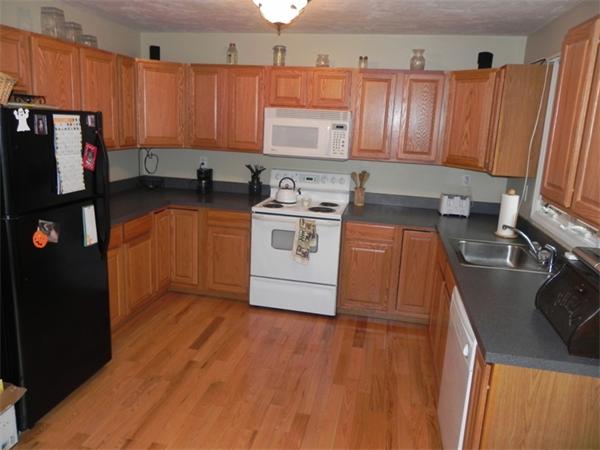 536 Cutler Road Barre, MA 01005 - Photo 2 of 24 a kitchen with stainless steel appliances a stove a refrigerator a sink and wooden cabinets