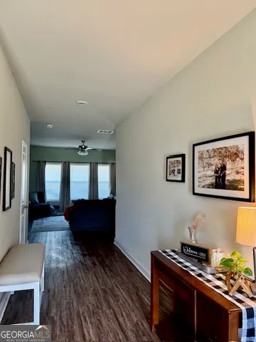 a living room with furniture and kitchen view