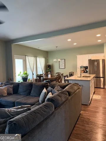 a kitchen with a sink a refrigerator and a stove top oven