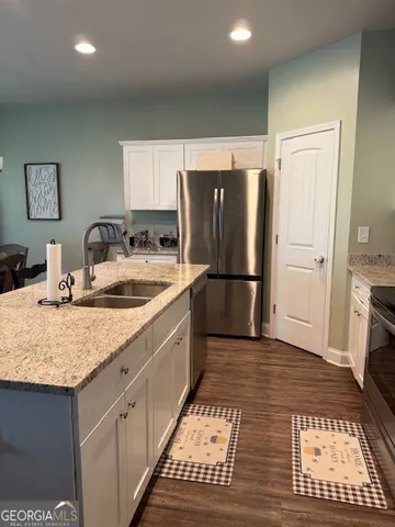 a kitchen with sink refrigerator and large window