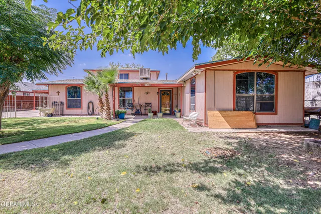 a front view of a house with outdoor seating