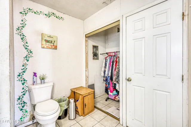a view of dirt yard with a large tree
