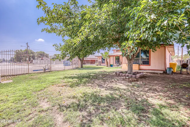 a view of a house with a yard and sitting area