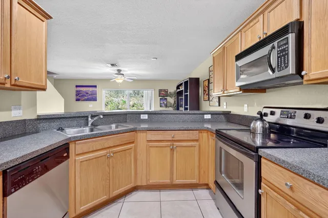 a kitchen with a sink cabinets and window