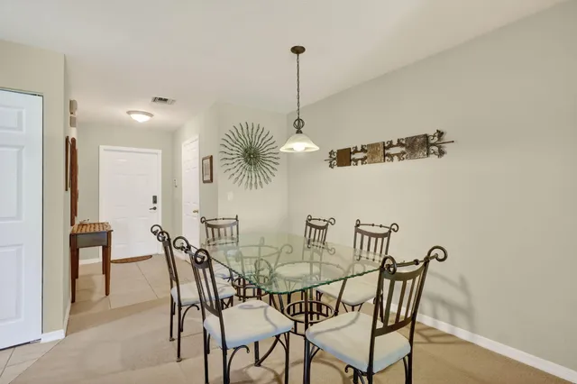 a view of a dining room with furniture and chandelier