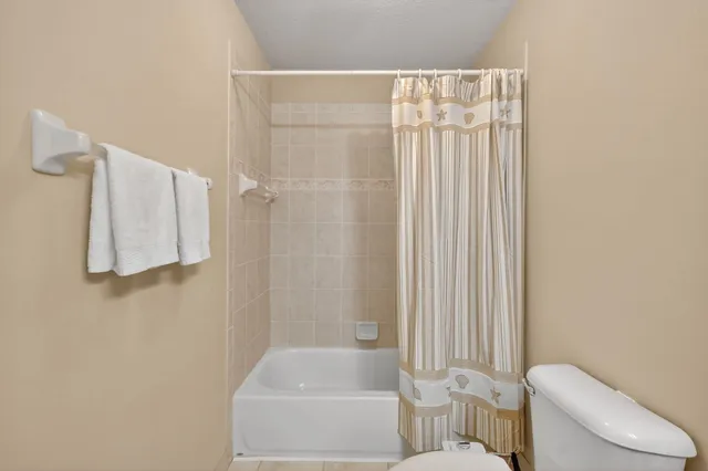 a bathroom with a toilet and shower