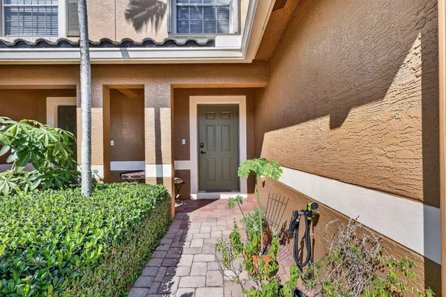 a front view of a house with a yard and flowers