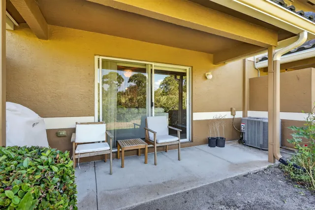 a balcony with furniture and a potted plant
