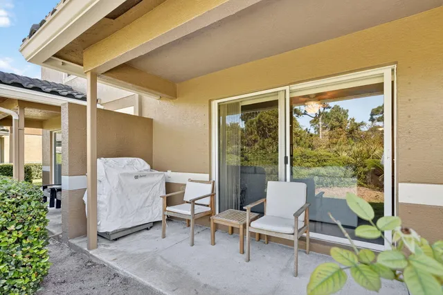 a view of a balcony with chair and table