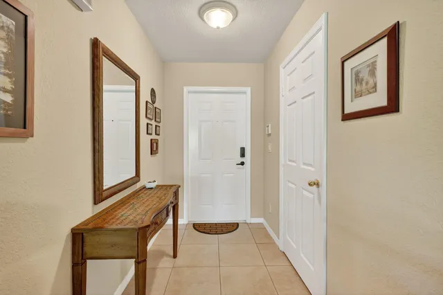 a hallway with front door and wooden floor