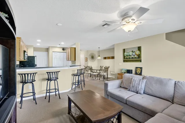 a living room with furniture kitchen view and a dining table