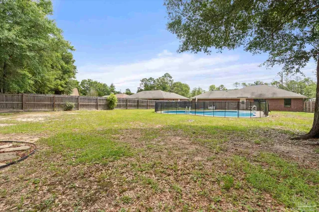 a view of a swimming pool with an outdoor seating and a garden