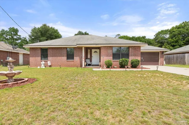 a front view of house with yard and green space