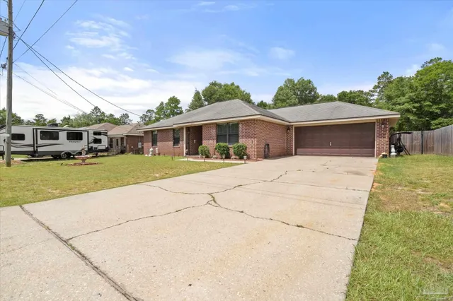 a view of a white house with a big yard and large trees