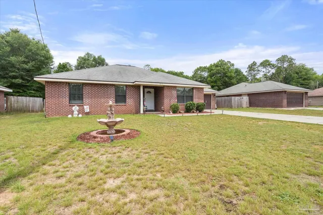a front view of a house with swimming pool yard and patio