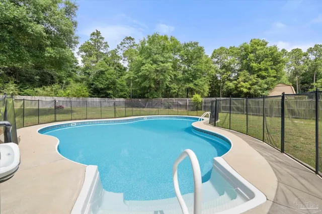 a view of a swimming pool with a patio