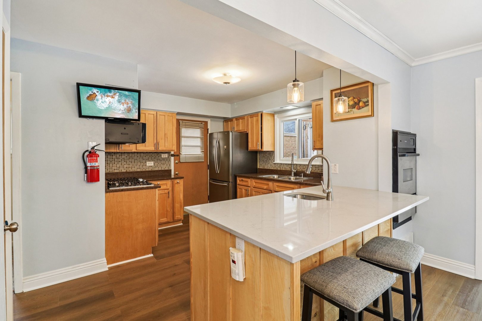 2931 Greenleaf Avenue Wilmette, IL 60091 - Photo 11 of 44 a kitchen with a refrigerator a stove top oven a counter space and wooden floor