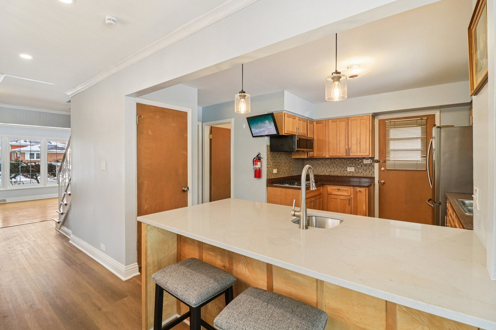 2931 Greenleaf Avenue Wilmette, IL 60091 - Photo 12 of 44 a kitchen with stainless steel appliances kitchen island granite countertop a refrigerator a stove and a sink with cabinets