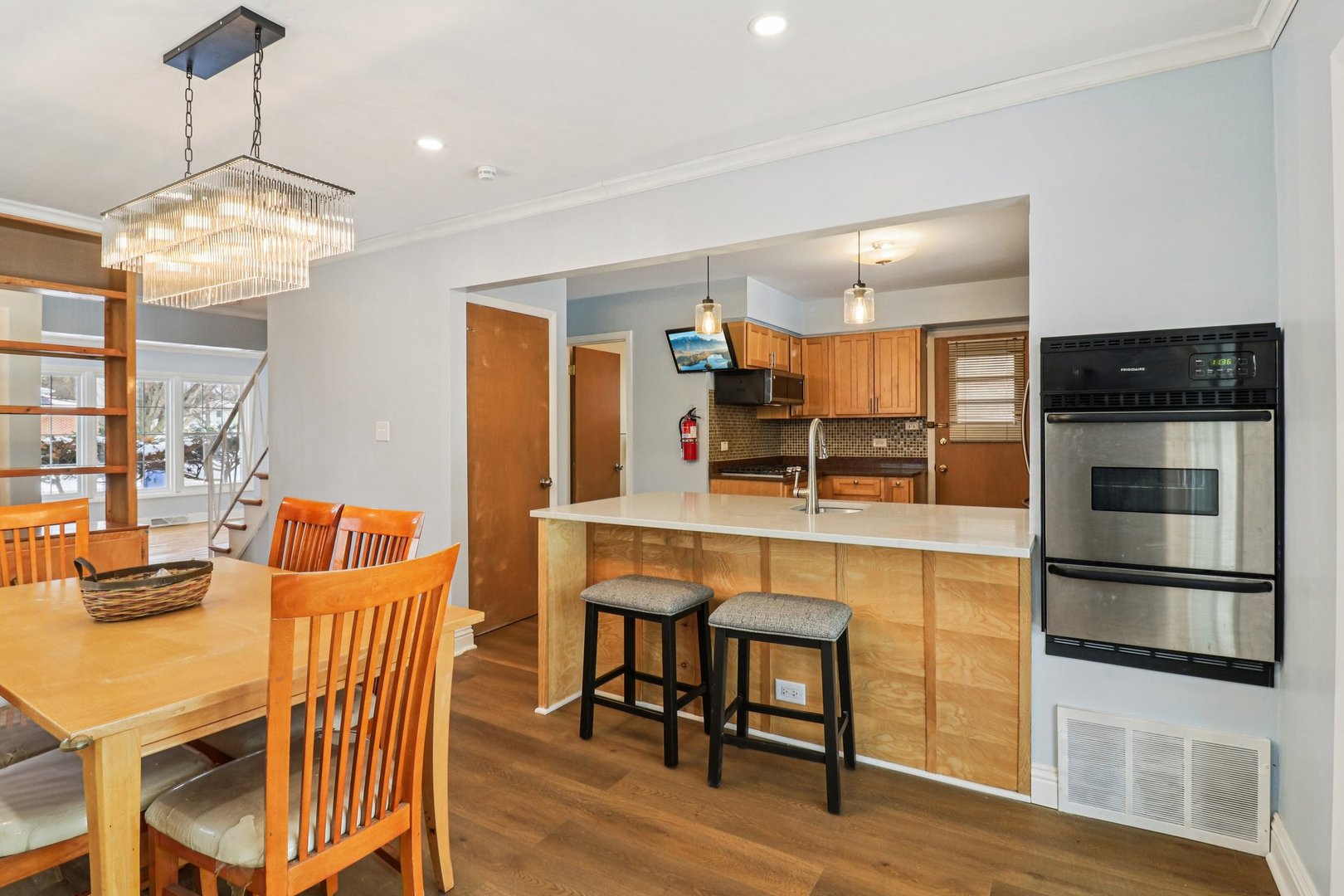 2931 Greenleaf Avenue Wilmette, IL 60091 - Photo 10 of 44 a view of a dining room with furniture a chandelier and wooden floor