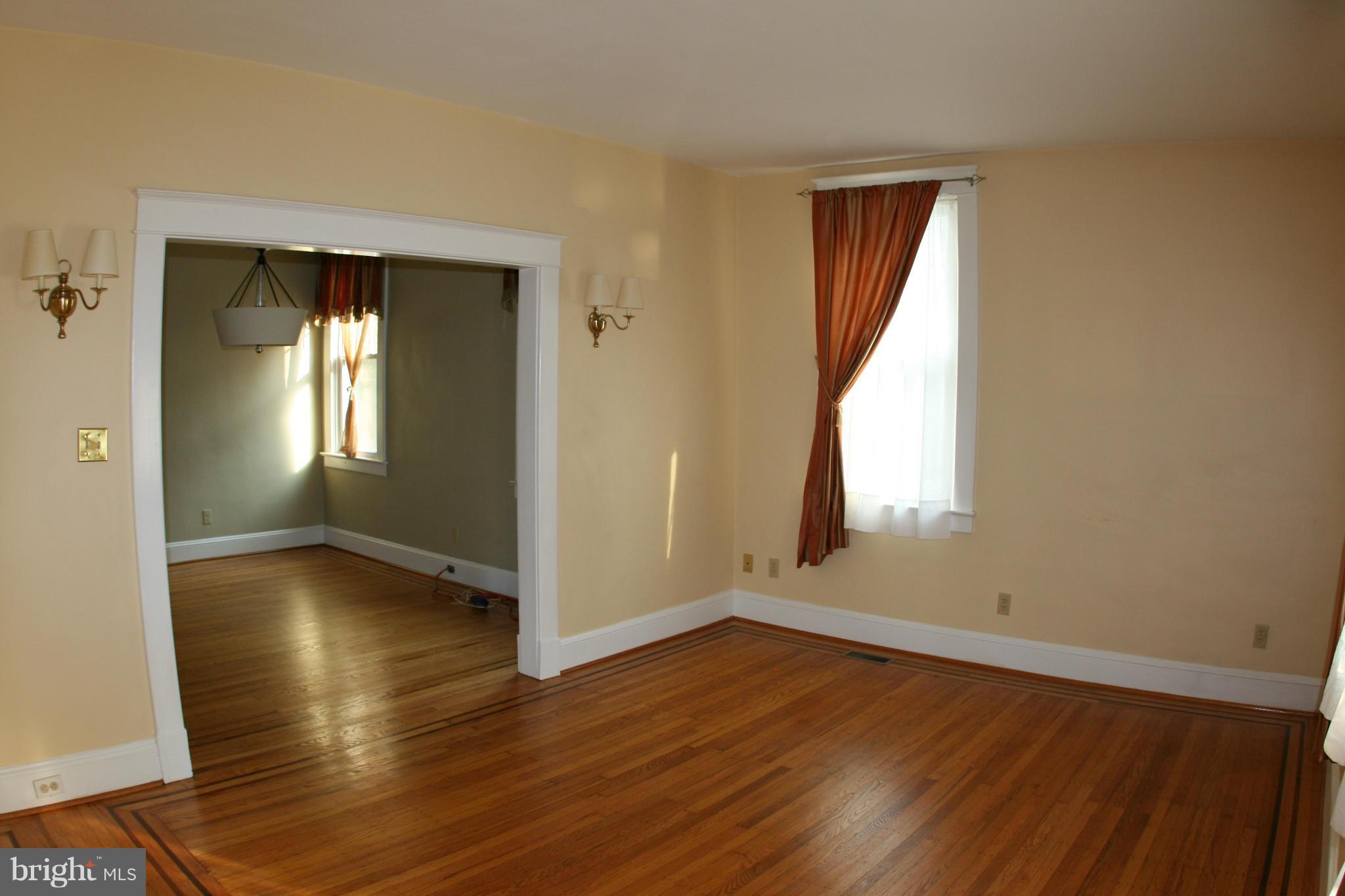 23 Edmondson Ridge Road Catonsville, MD 21228 - Photo 2 of 18 an empty room with wooden floor and windows