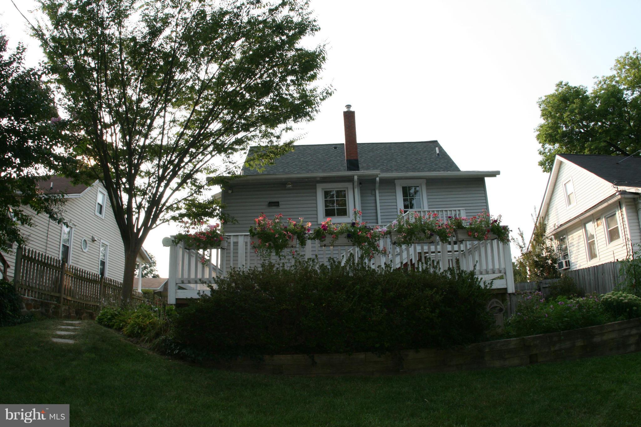 23 Edmondson Ridge Road Catonsville, MD 21228 - Photo 17 of 18 a front view of a house with a garden