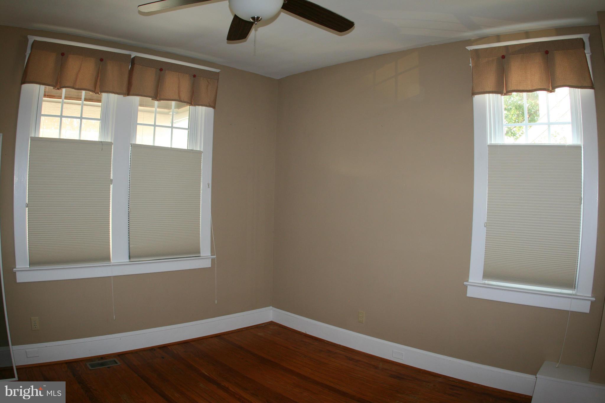 23 Edmondson Ridge Road Catonsville, MD 21228 - Photo 8 of 18 a view of an empty room with wooden floor and a window