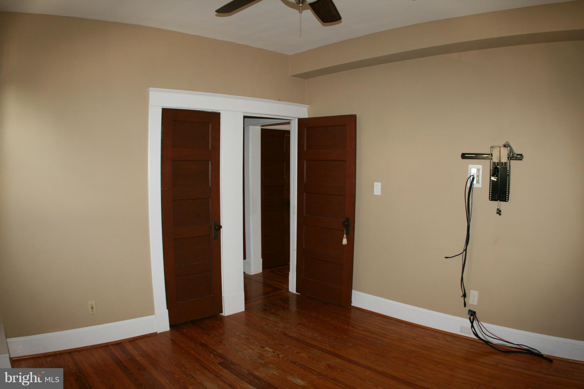 23 Edmondson Ridge Road Catonsville, MD 21228 - Photo 9 of 18 an empty room with wooden floor and ceiling fan