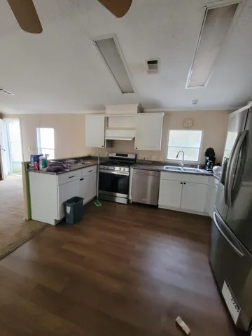 a view of a room with a kitchen