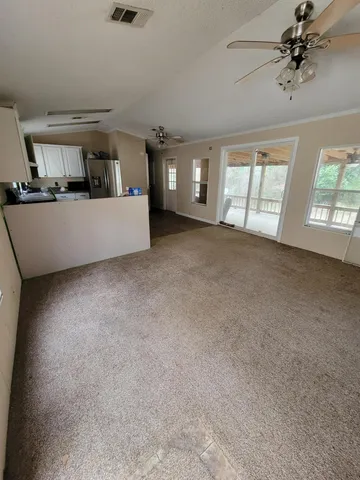 a kitchen with stainless steel appliances granite countertop a refrigerator a stove top oven a sink and dishwasher