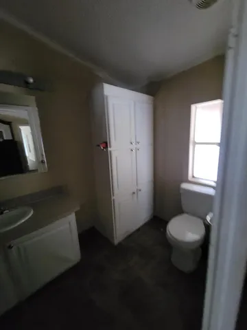 a view of a livingroom with a ceiling fan and window